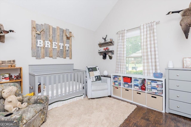 311 Kendall Ct, Perry, GA 31069 - bedroom featuring vaulted ceiling, wood finished floors, and a nursery area