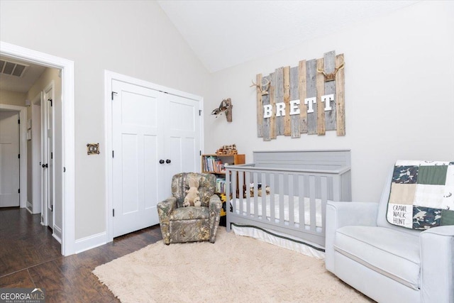 311 Kendall Ct, Perry, GA 31069 - bedroom with wood finished floors, vaulted ceiling, a closet, and a crib