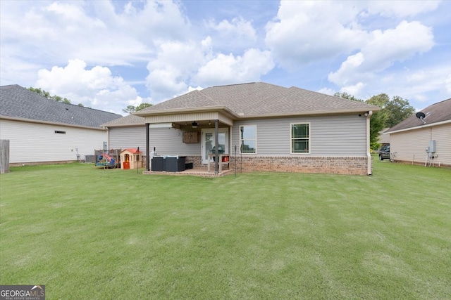 311 Kendall Ct, Perry, GA 31069 - back of house with a patio area, a yard, roof with shingles, and brick siding