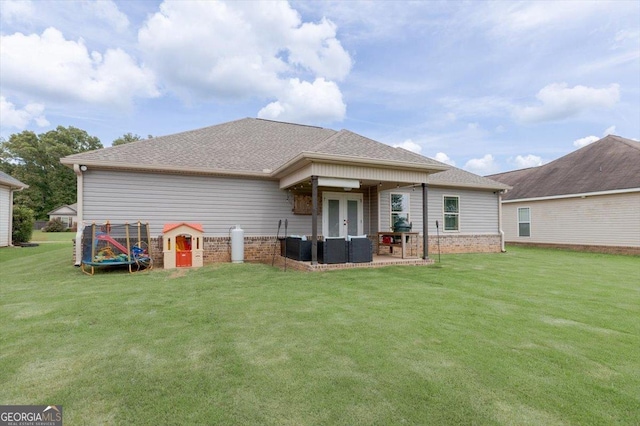 311 Kendall Ct, Perry, GA 31069 - rear view of house featuring french doors, a lawn, brick siding, a patio, and roof with shingles