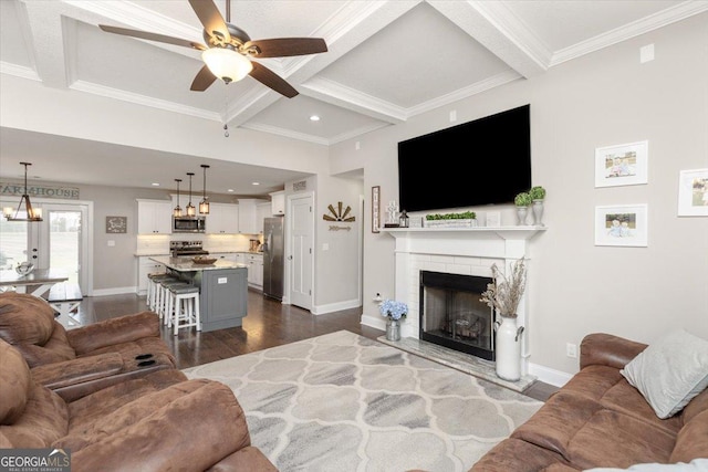 311 Kendall Ct, Perry, GA 31069 - living area featuring beamed ceiling, a ceiling fan, a brick fireplace, dark wood finished floors, and crown molding