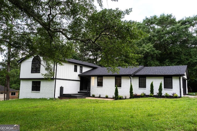 69 N Hearn Rd, Ellenwood, GA 30294 - tri-level home with brick siding, a front lawn, and roof with shingles