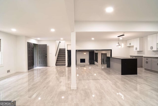 69 N Hearn Rd, Ellenwood, GA 30294 - unfurnished living room with recessed lighting and stairs