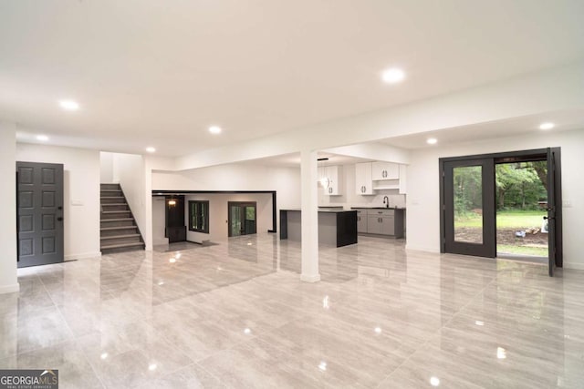 69 N Hearn Rd, Ellenwood, GA 30294 - unfurnished living room featuring stairs, recessed lighting, and light marble finish flooring