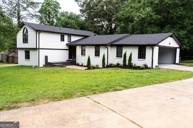 69 N Hearn Rd, Ellenwood, GA 30294 - tri-level home with driveway, brick siding, a shingled roof, a front lawn, and an attached garage
