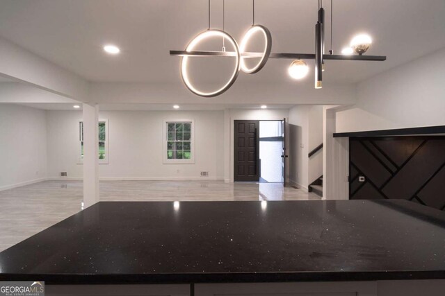 69 N Hearn Rd, Ellenwood, GA 30294 - kitchen featuring open floor plan, light wood-style flooring, recessed lighting, and stone counters