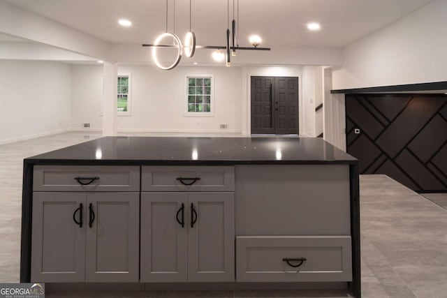 69 N Hearn Rd, Ellenwood, GA 30294 - kitchen with gray cabinetry, open floor plan, recessed lighting, hanging light fixtures, and a center island