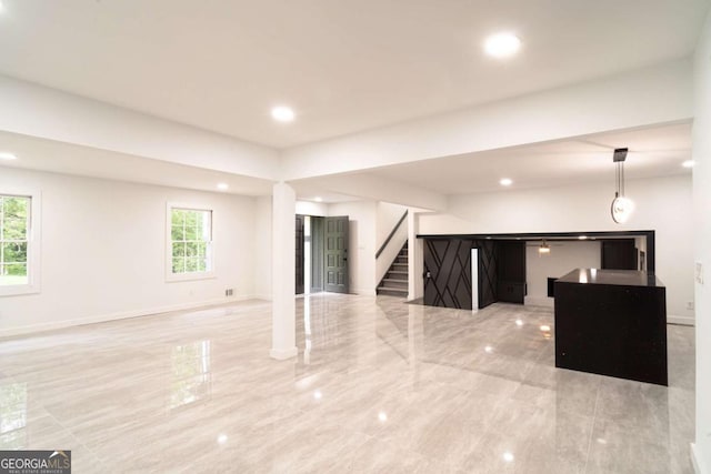 69 N Hearn Rd, Ellenwood, GA 30294 - unfurnished living room with stairway and recessed lighting
