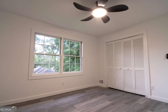 69 N Hearn Rd, Ellenwood, GA 30294 - unfurnished bedroom featuring wood finished floors, a closet, and a ceiling fan