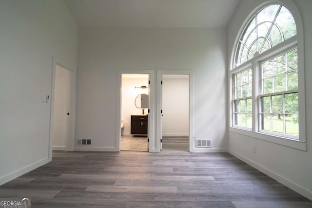 69 N Hearn Rd, Ellenwood, GA 30294 - unfurnished bedroom featuring wood finished floors, high vaulted ceiling, and ensuite bath