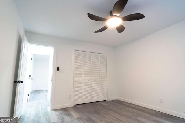 69 N Hearn Rd, Ellenwood, GA 30294 - unfurnished bedroom with wood finished floors, a closet, and a ceiling fan