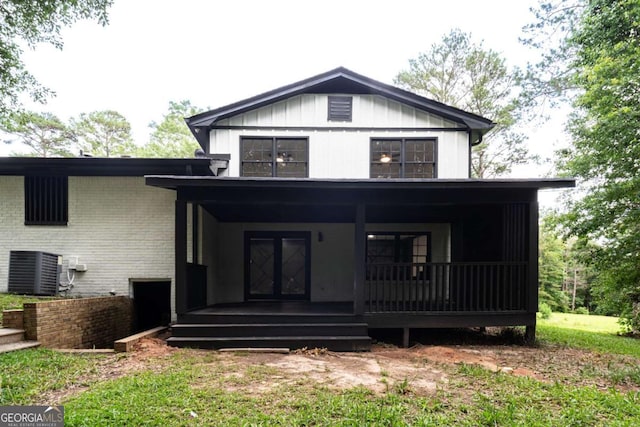 69 N Hearn Rd, Ellenwood, GA 30294 - view of front of property featuring covered porch, board and batten siding, and brick siding