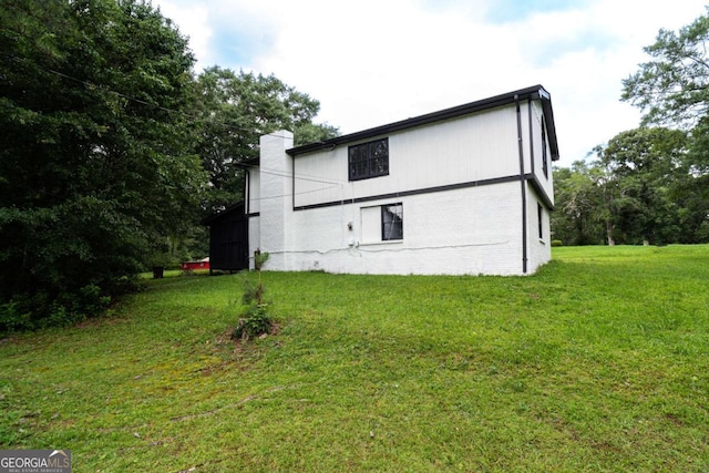 69 N Hearn Rd, Ellenwood, GA 30294 - view of side of property with a lawn, a chimney, and brick siding