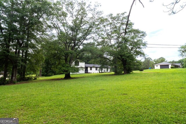 69 N Hearn Rd, Ellenwood, GA 30294 - view of grassy yard featuring a garage