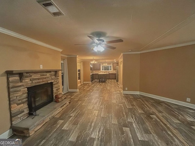 175 Bob White St, Jesup, GA 31545 - unfurnished living room featuring dark wood-style flooring, ceiling fan, crown molding, and a fireplace