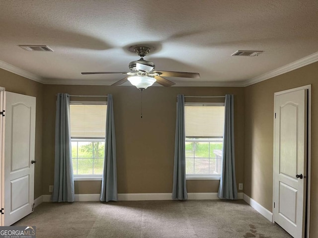 175 Bob White St, Jesup, GA 31545 - unfurnished bedroom with carpet flooring, a textured ceiling, multiple windows, ornamental molding, and ceiling fan