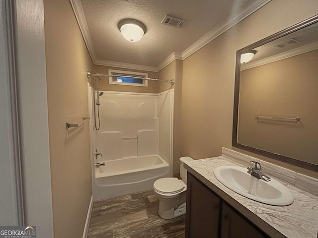175 Bob White St, Jesup, GA 31545 - bathroom featuring vanity, a textured ceiling, washtub / shower combination, wood finished floors, and ornamental molding