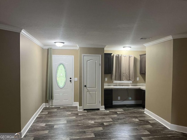 175 Bob White St, Jesup, GA 31545 - entryway with dark wood finished floors, built in study area, crown molding, and a textured ceiling