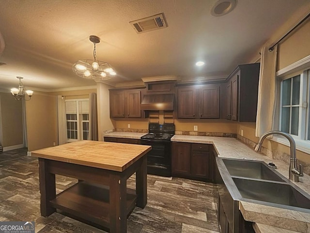 175 Bob White St, Jesup, GA 31545 - kitchen with black / electric stove, under cabinet range hood, a chandelier, dark brown cabinetry, and crown molding