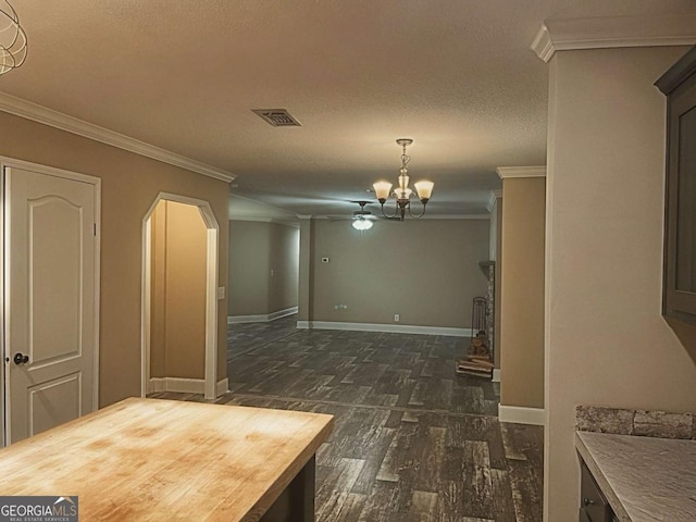 175 Bob White St, Jesup, GA 31545 - empty room featuring dark wood finished floors, ornamental molding, arched walkways, a ceiling fan, and a textured ceiling