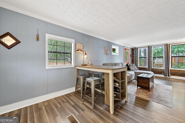 321 Barbara Point Rd, Sparta, GA 31087 - dining space with crown molding, plenty of natural light, a textured ceiling, and wood finished floors