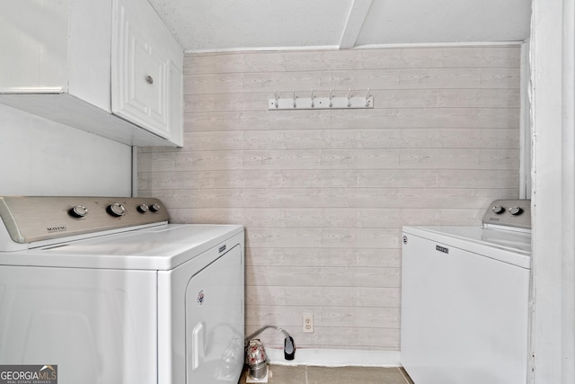 321 Barbara Point Rd, Sparta, GA 31087 - laundry room featuring separate washer and dryer, cabinet space, and wood walls
