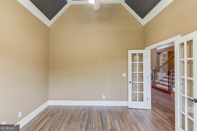 3217 Aberrone Pl, Buford, GA 30519 - spare room featuring french doors, wood finished floors, a ceiling fan, high vaulted ceiling, and stairway