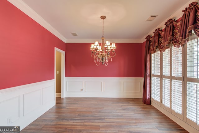 3217 Aberrone Pl, Buford, GA 30519 - unfurnished dining area featuring a chandelier, plenty of natural light, wainscoting, ornamental molding, and wood finished floors