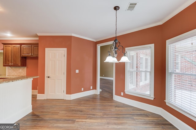 3217 Aberrone Pl, Buford, GA 30519 - unfurnished dining area featuring crown molding, a chandelier, and light wood-type flooring