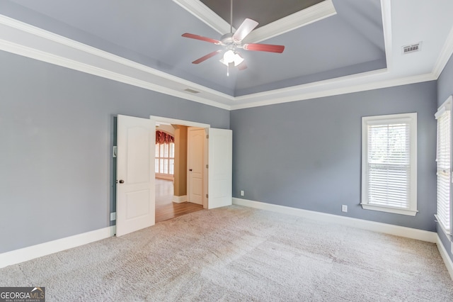 3217 Aberrone Pl, Buford, GA 30519 - empty room featuring carpet flooring, ceiling fan, crown molding, and a raised ceiling