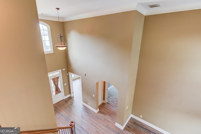 3217 Aberrone Pl, Buford, GA 30519 - stairs with arched walkways, wood finished floors, and crown molding
