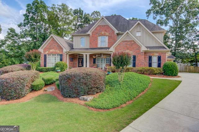 3217 Aberrone Pl, Buford, GA 30519 - view of front facade with board and batten siding, brick siding, and a porch