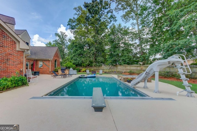 3217 Aberrone Pl, Buford, GA 30519 - view of pool with a water slide, a patio area, a diving board, and a fenced backyard