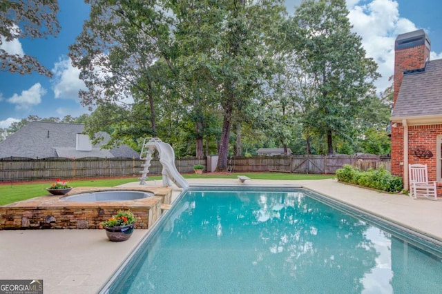 3217 Aberrone Pl, Buford, GA 30519 - view of swimming pool featuring a fenced backyard, an in-ground hot tub, a water slide, and a patio area