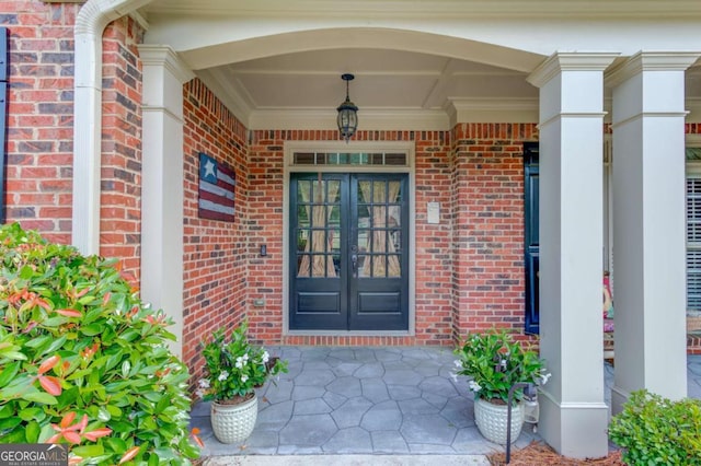 3217 Aberrone Pl, Buford, GA 30519 - view of exterior entry featuring brick siding, covered porch, and french doors