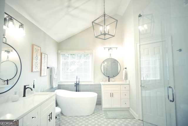361 Fairway Cir, Monroe, GA 30656 - bathroom with vaulted ceiling, a stall shower, two vanities, a soaking tub, and a chandelier