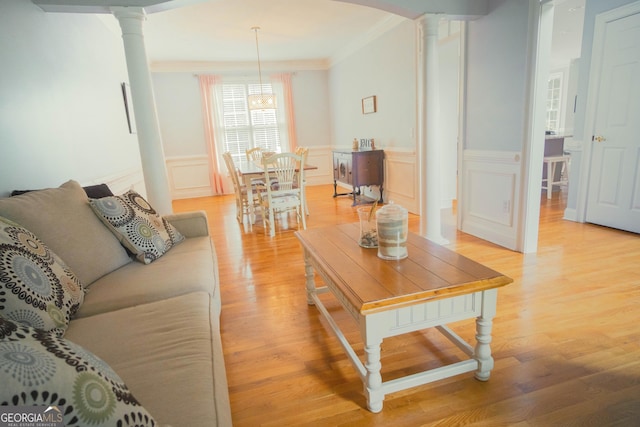 361 Fairway Cir, Monroe, GA 30656 - living area featuring decorative columns, ornamental molding, light wood finished floors, a wainscoted wall, and a decorative wall