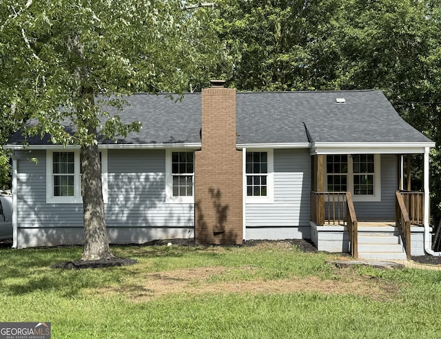 2039 Gober Ave SE, Smyrna, GA 30080 - back of house with a yard, a chimney, a porch, and roof with shingles