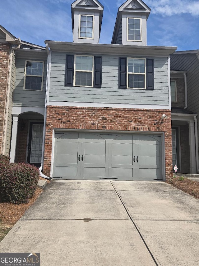 3511 Brockenhurst Dr, Buford, GA 30519 - view of front of property featuring driveway, an attached garage, and brick siding