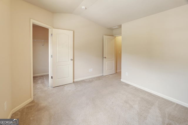3511 Brockenhurst Dr, Buford, GA 30519 - unfurnished bedroom featuring lofted ceiling, carpet floors, a spacious closet, and a closet