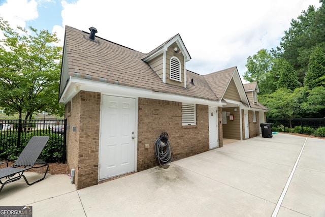 3511 Brockenhurst Dr, Buford, GA 30519 - view of side of property with a patio, brick siding, and a shingled roof