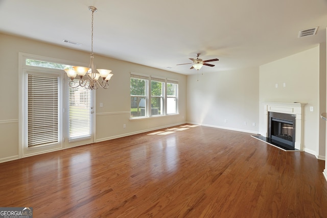 3511 Brockenhurst Dr, Buford, GA 30519 - unfurnished living room featuring a chandelier, a glass covered fireplace, a ceiling fan, and wood finished floors