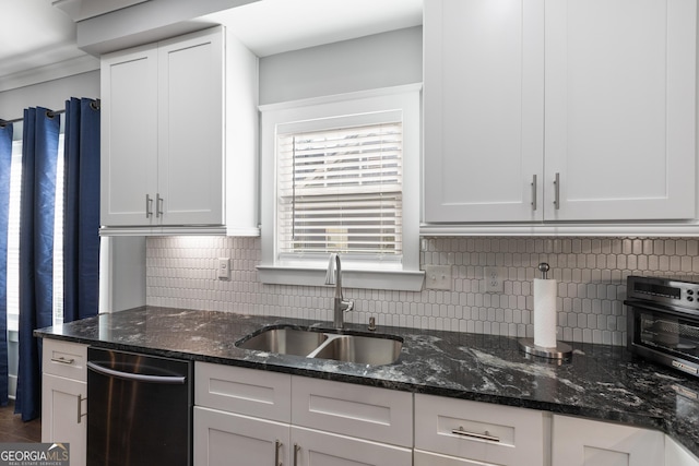 1967 Cogar Dr, Decatur, GA 30032 - kitchen with stainless steel dishwasher, tasteful backsplash, and white cabinetry