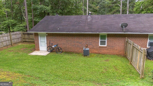 1777 Cedar Shoals Dr Unit 1775, Athens, GA 30605 - rear view of house featuring brick siding, a fenced backyard, and roof with shingles