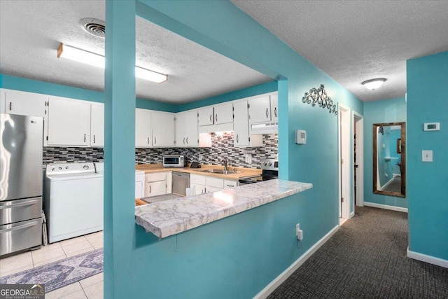 1777 Cedar Shoals Dr Unit 1775, Athens, GA 30605 - kitchen with stainless steel appliances, a textured ceiling, under cabinet range hood, white cabinetry, and tasteful backsplash