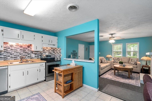 1777 Cedar Shoals Dr Unit 1775, Athens, GA 30605 - kitchen featuring stainless steel appliances, under cabinet range hood, backsplash, white cabinets, and light countertops