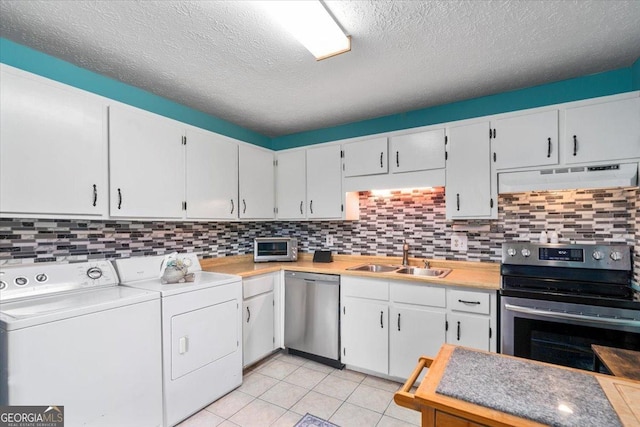 1777 Cedar Shoals Dr Unit 1775, Athens, GA 30605 - kitchen featuring stainless steel appliances, extractor fan, independent washer and dryer, light countertops, and a textured ceiling