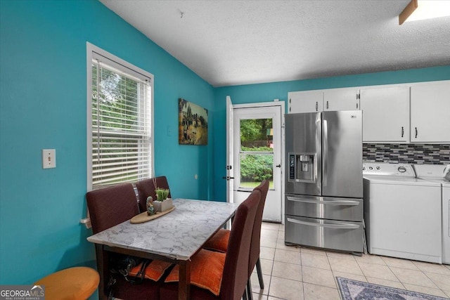 1777 Cedar Shoals Dr Unit 1775, Athens, GA 30605 - kitchen featuring stainless steel fridge with ice dispenser, washer and dryer, plenty of natural light, light tile patterned floors, and a textured ceiling