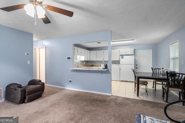1777 Cedar Shoals Dr Unit 1775, Athens, GA 30605 - living area with a ceiling fan, light colored carpet, light tile patterned floors, and a textured ceiling