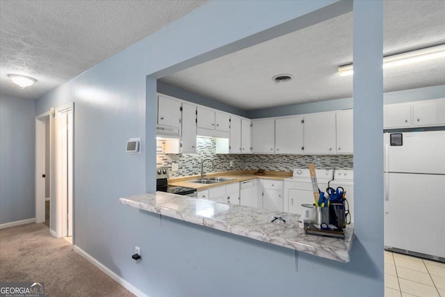 1777 Cedar Shoals Dr Unit 1775, Athens, GA 30605 - kitchen with white appliances, independent washer and dryer, a textured ceiling, extractor fan, and decorative backsplash